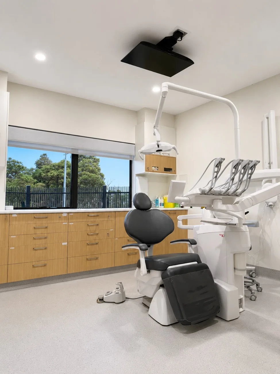 Treatment room with an open window and ceiling-mounted screen